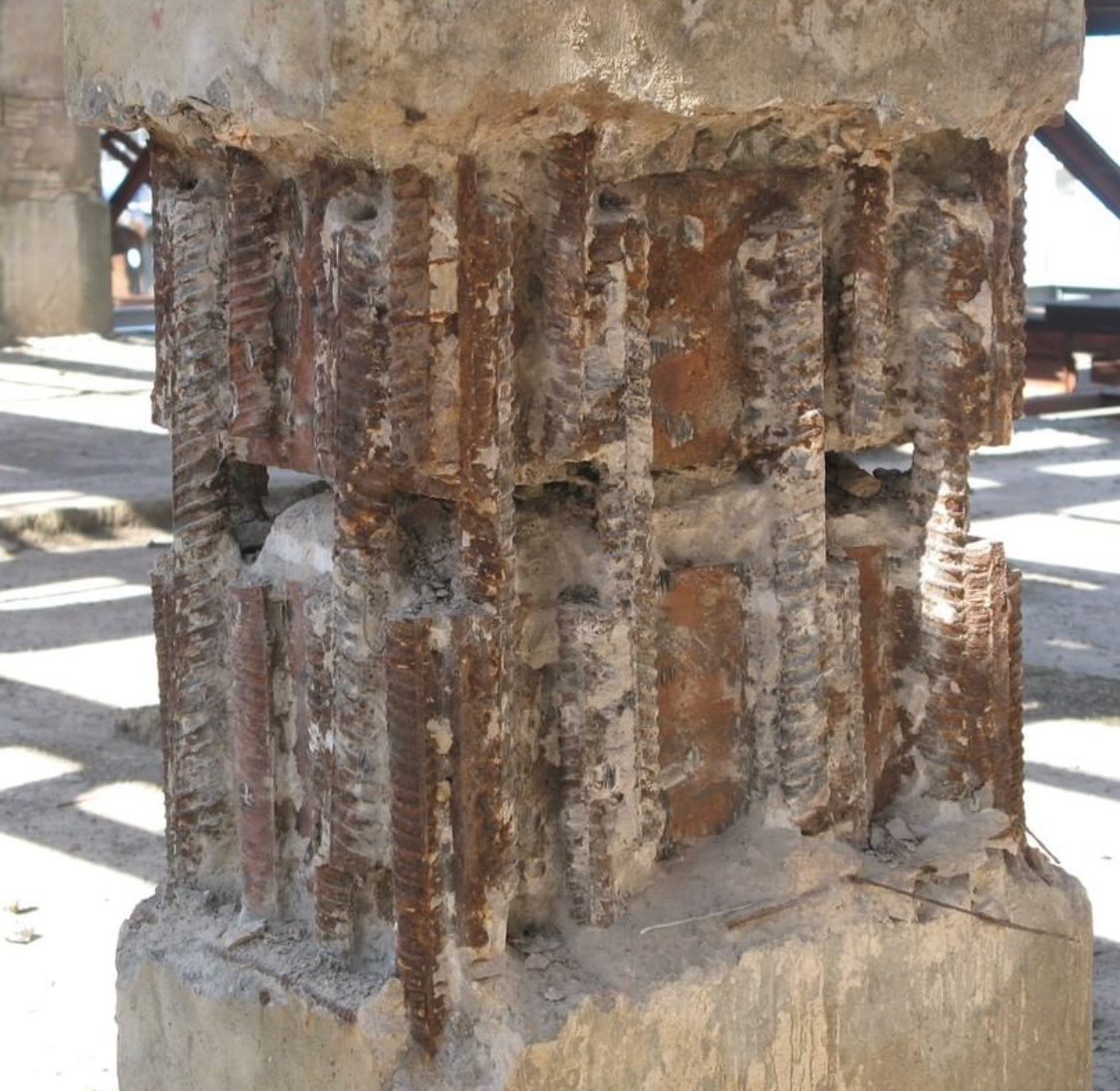 Фото бетонної колони з видимою іржавою арматурою